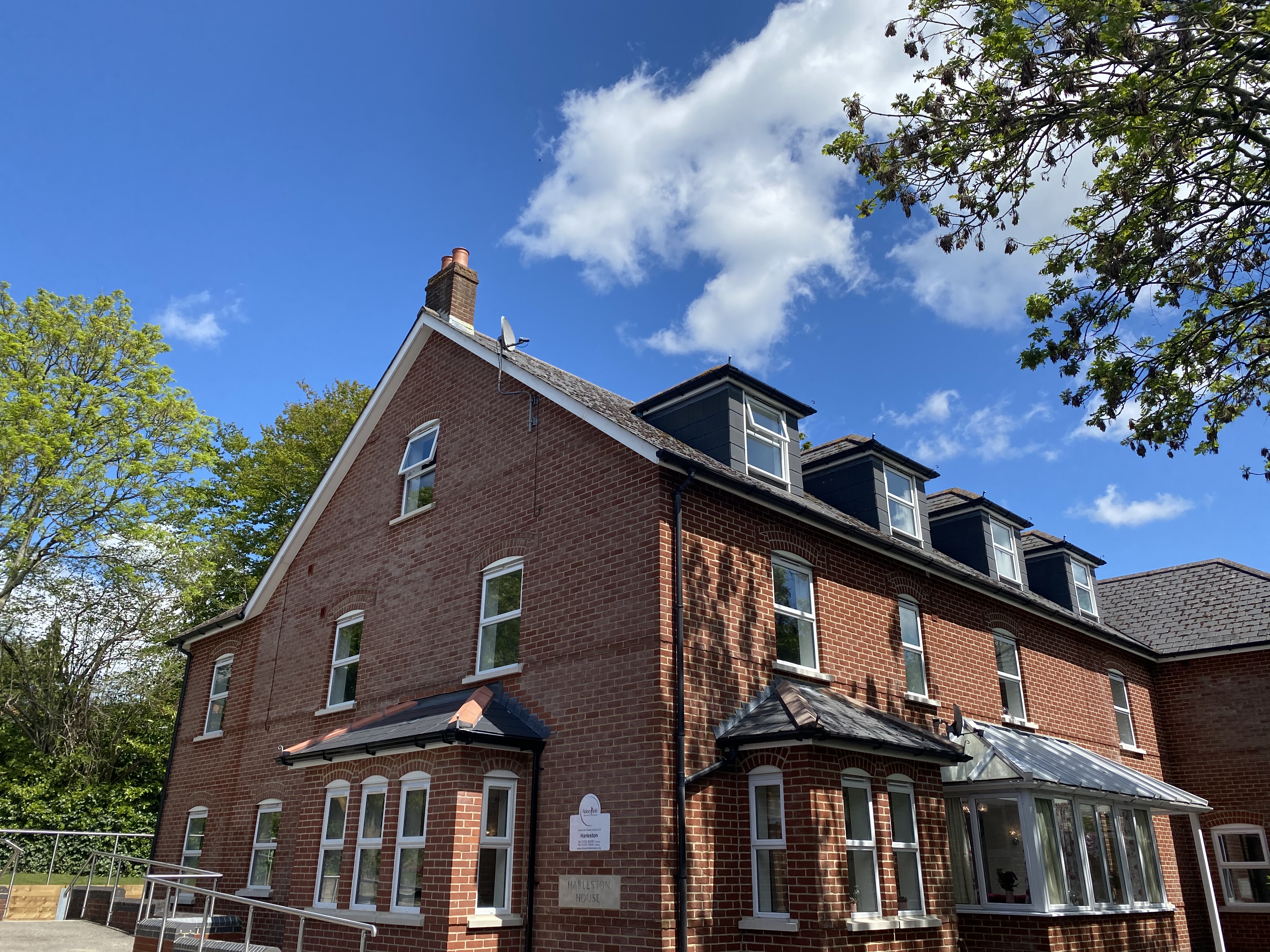 A view of Harleston House on a bright sunny day