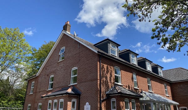A view of Harleston House on a bright sunny day