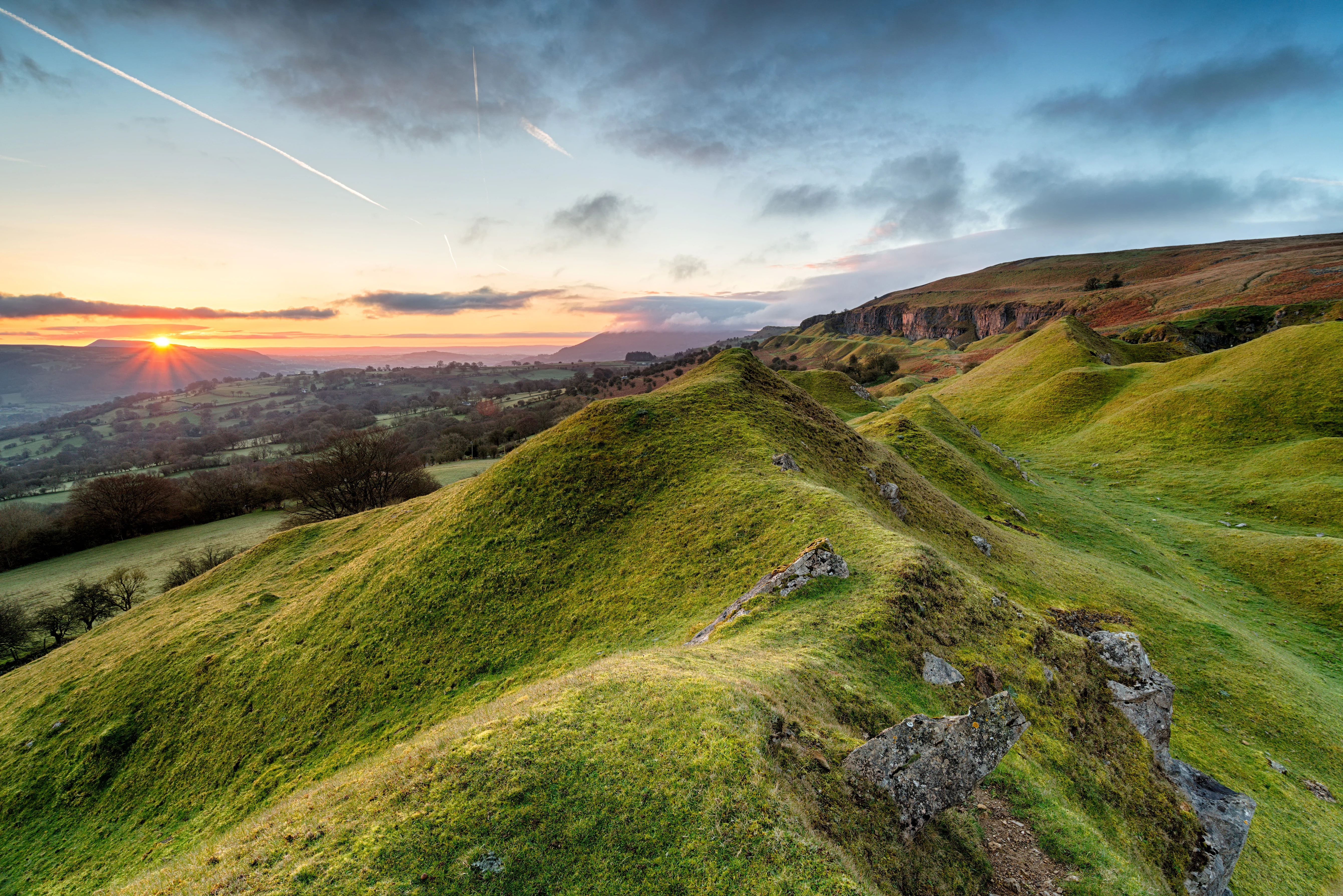 A landscape of the brecon beacons with the sun setting 