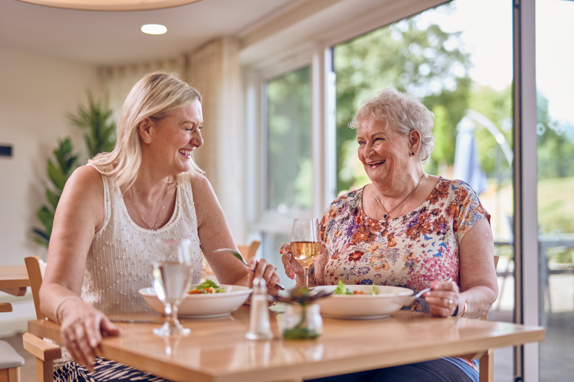 Two Women Sitting Together Enjoying Lunch