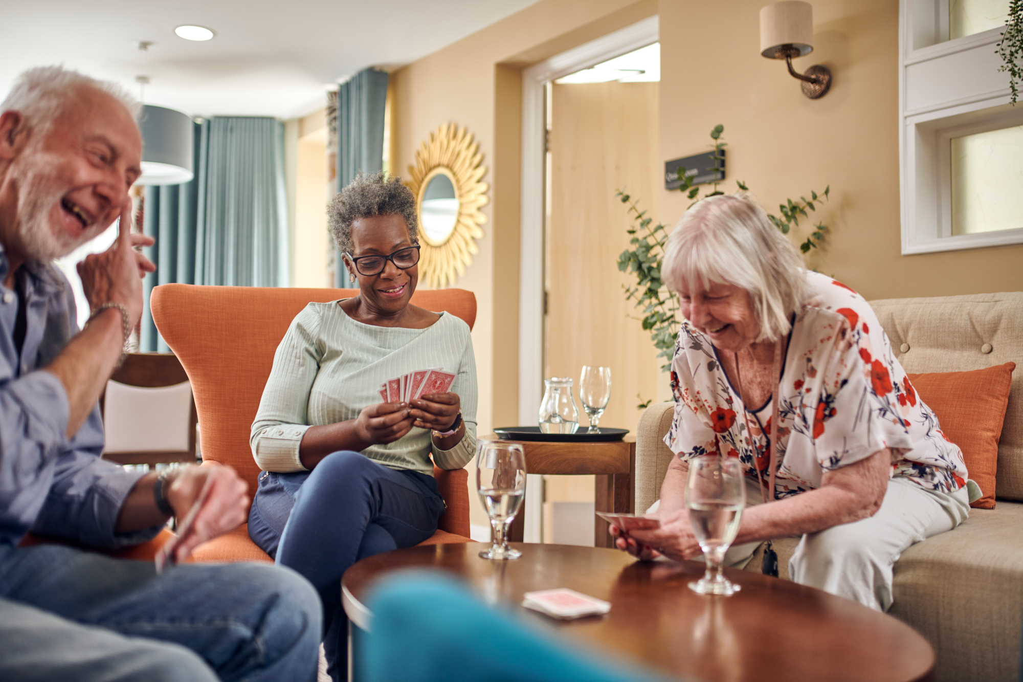 Group Of Older People Sitting Together Playing Cards