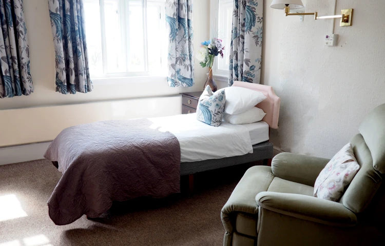 Single bed and chair at Hill House
