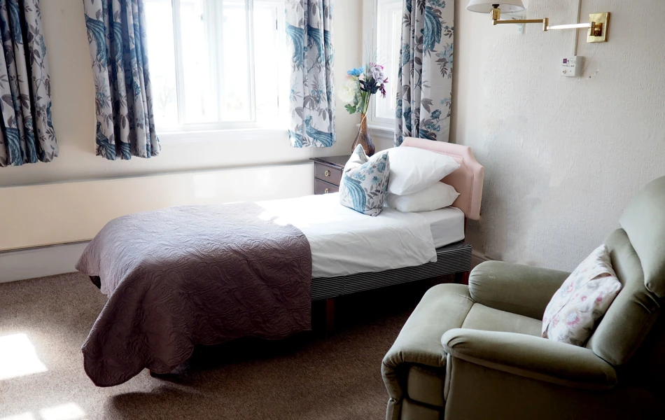 Single bed and chair at Hill House