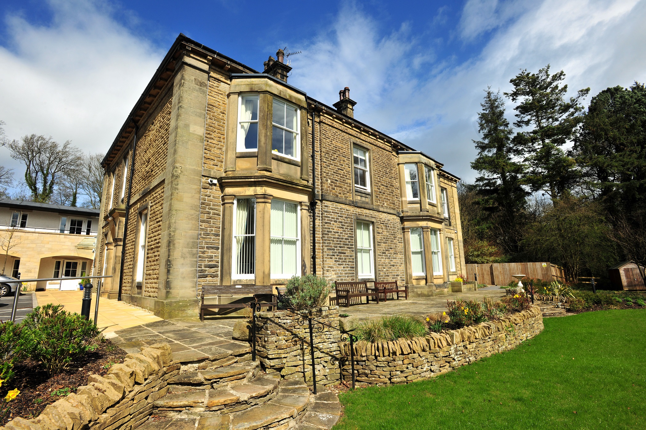 Woodlands a large stone house with stone wall and steps