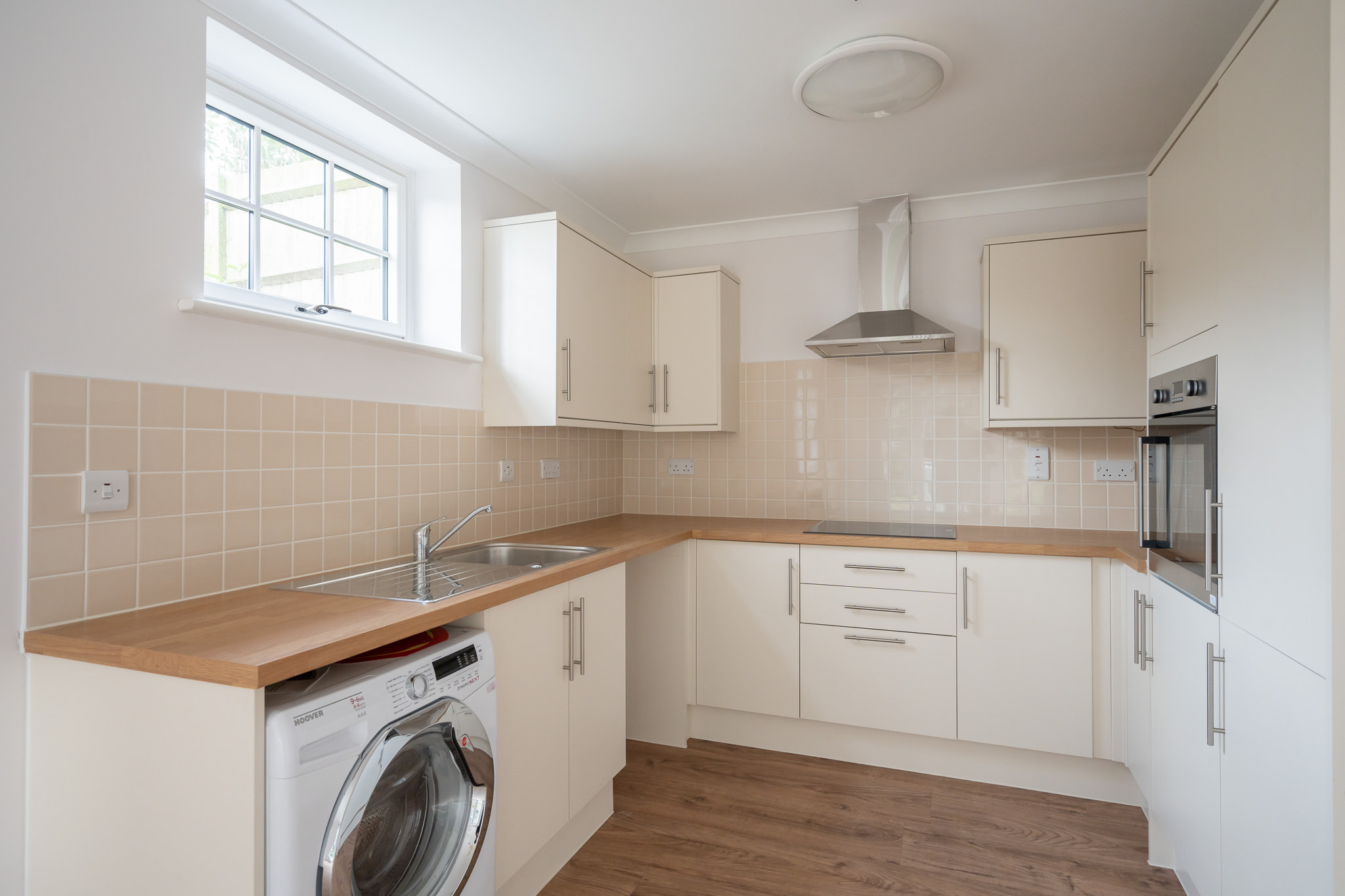 A kitchen with appliances and ample cupboard space