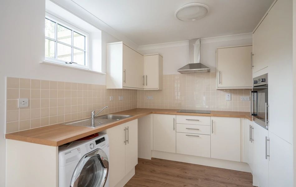 A kitchen with appliances and ample cupboard space