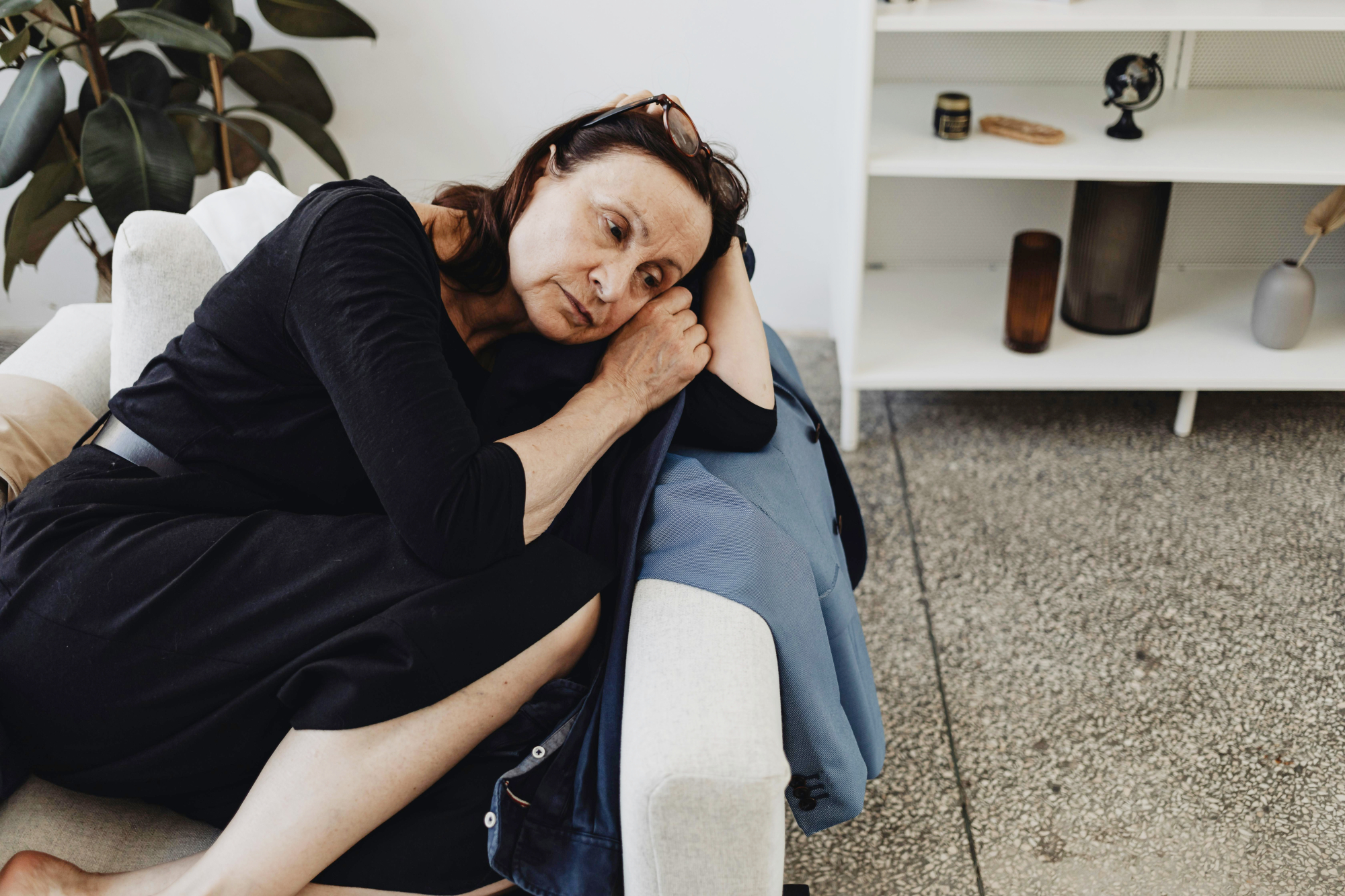 Older Woman Curled Up In Armchair