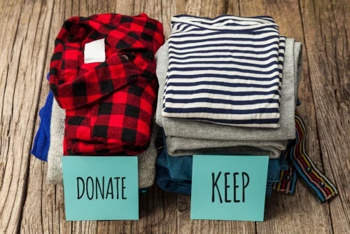 Two piles of clothing for donating or keeping