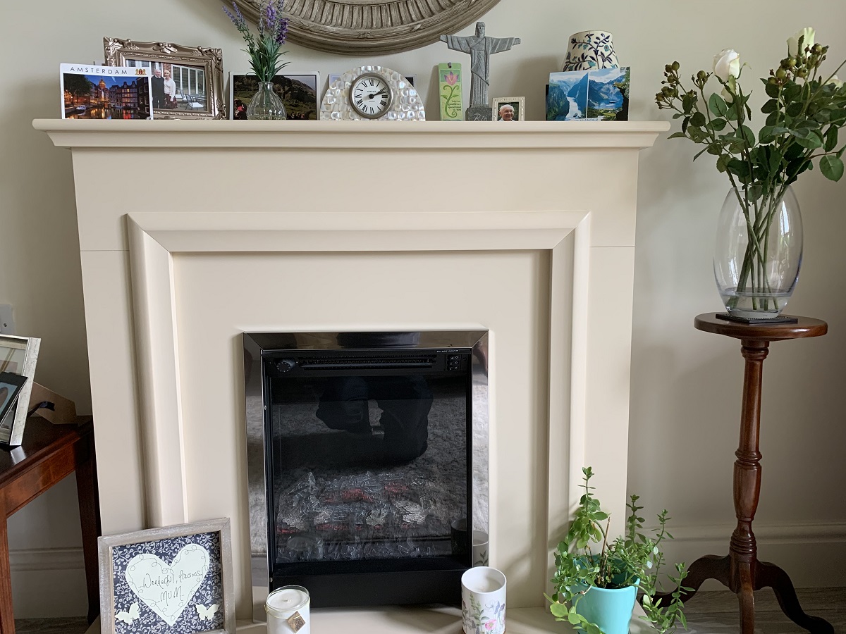 A residents fire place with photos and ornaments at The Firs