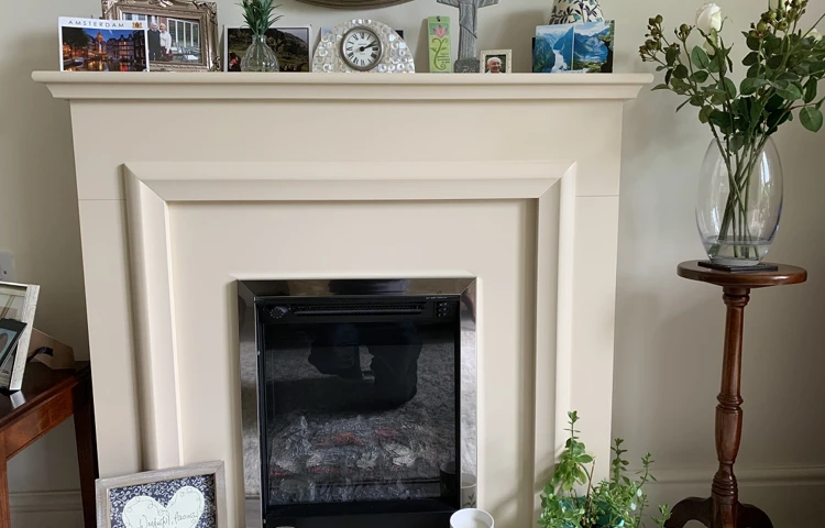 A residents fire place with photos and ornaments at The Firs