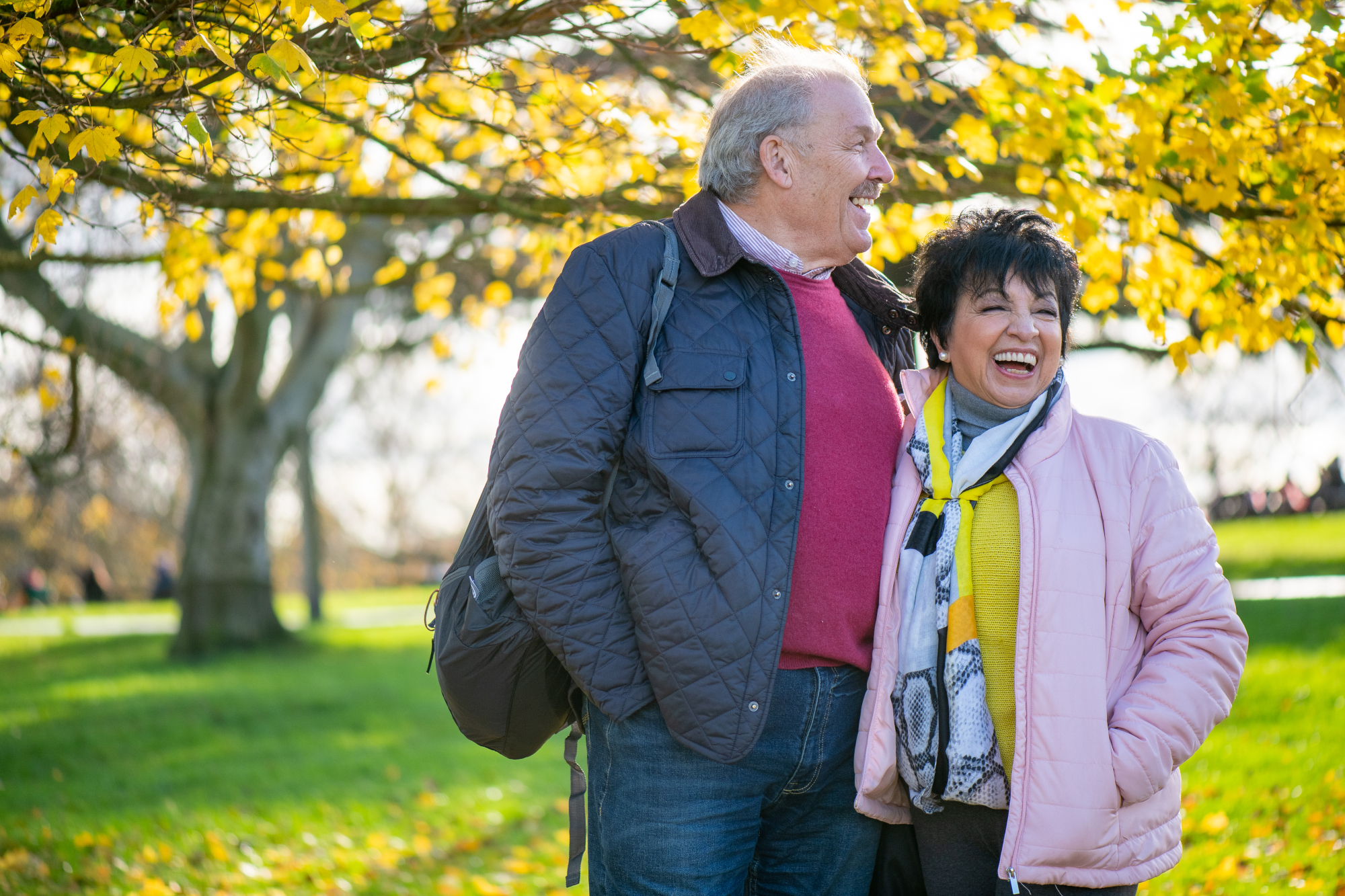 Smiling Older Couple Walking In A Park