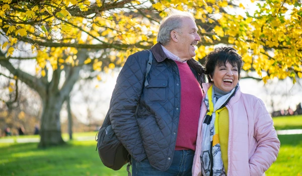 Smiling Older Couple Walking In A Park