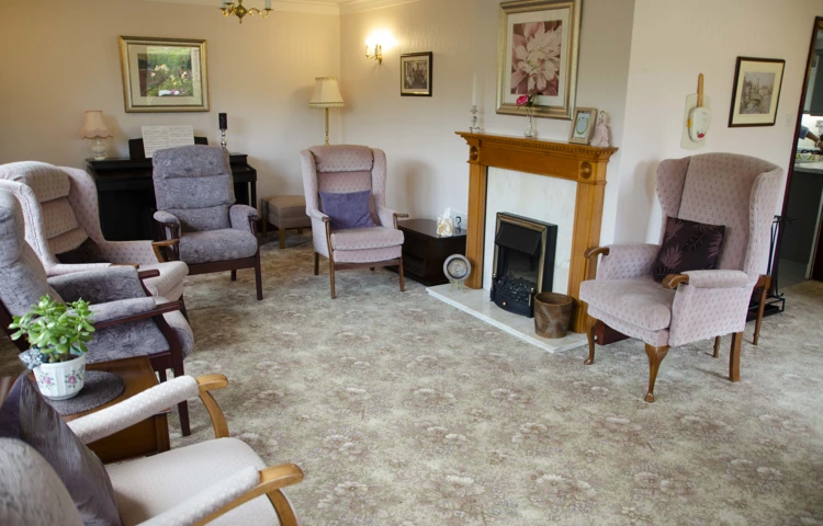 Lounge area with cosy lighting and high-back chairs at Castle View House, BB7 2DT
