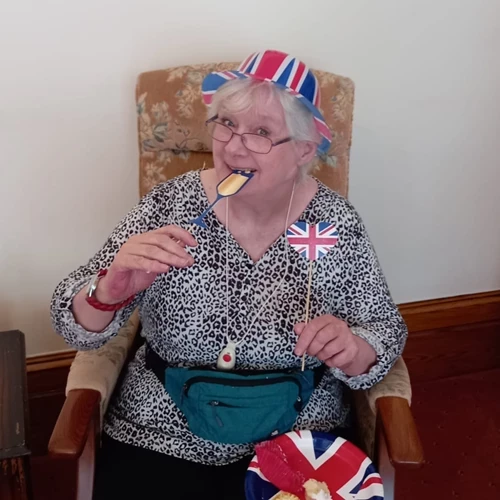 A woman posing with union jack sitcks