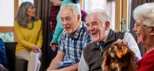 Happy smiling residents one stroking a dog