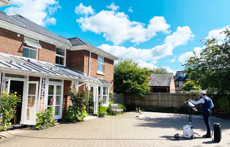 Saxophonist plays outside Abbeyfield House Romsey