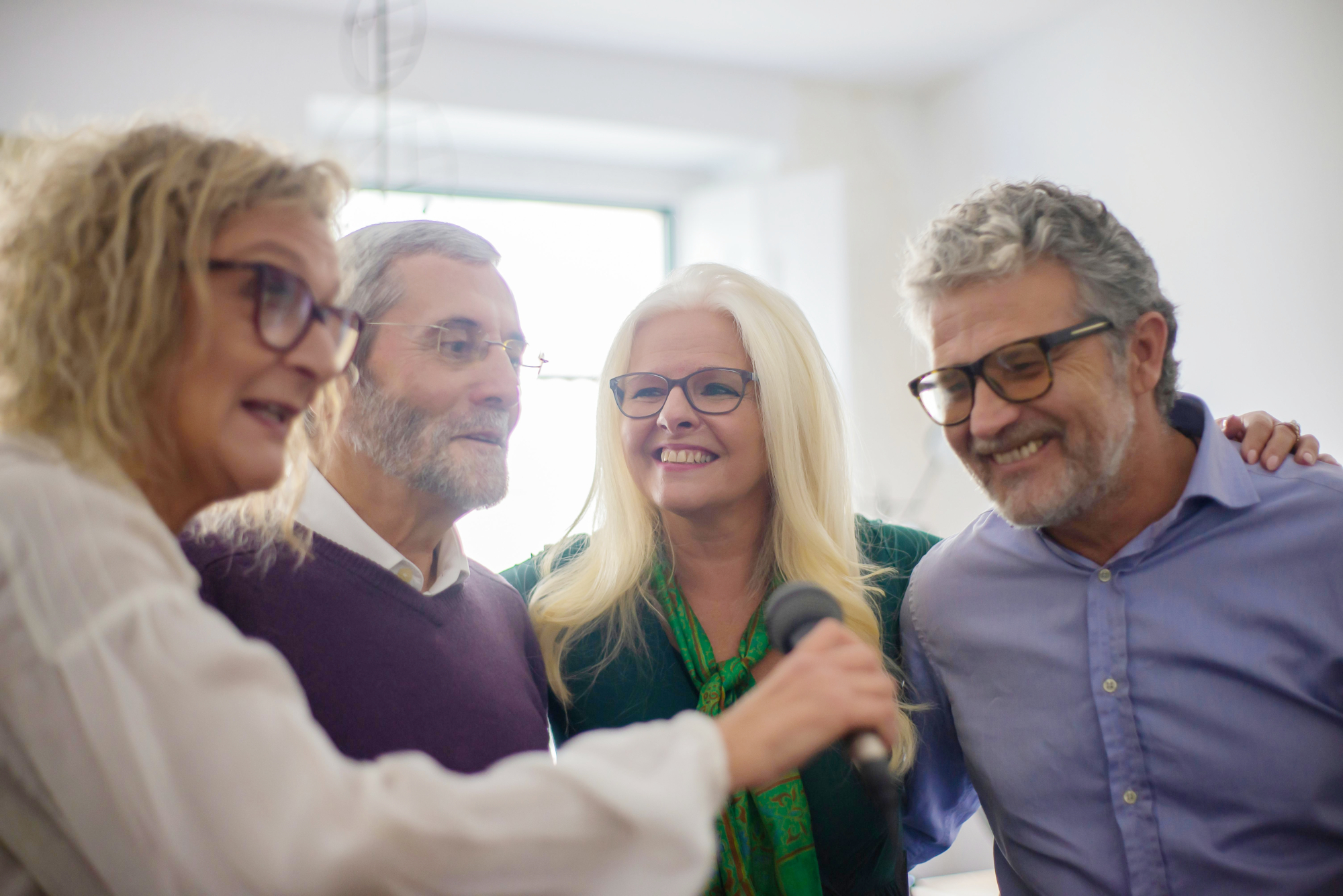 Group Of Older People Enjoying Karaoke Together