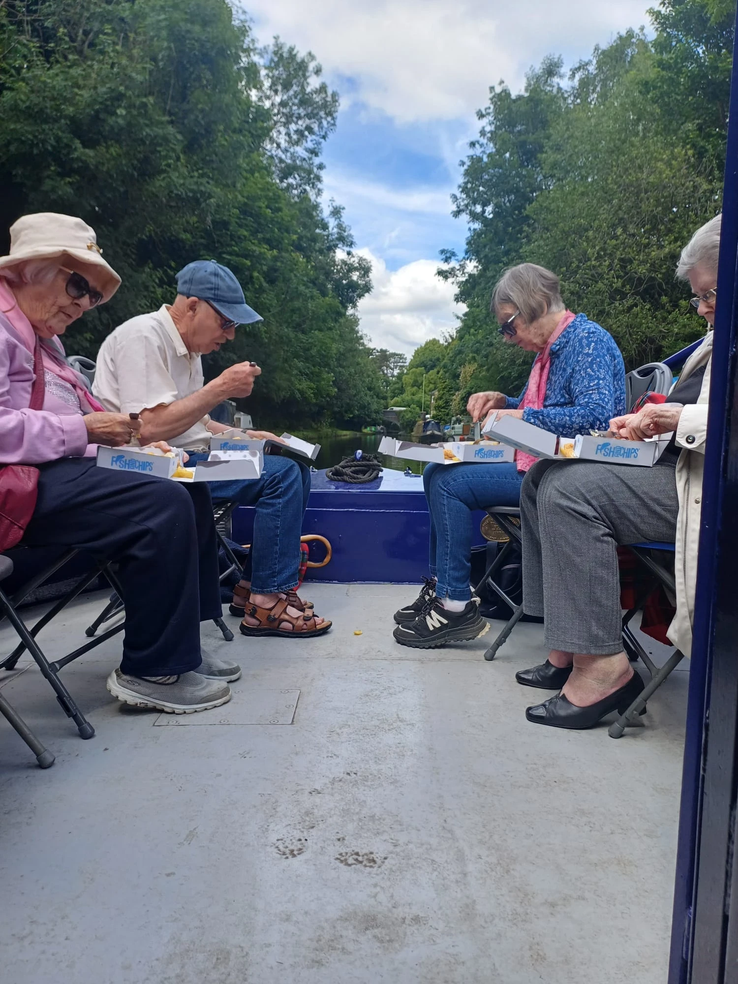 Residents eating fish and chips on the canal boat