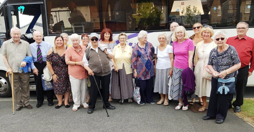 A group of residents standing outside a coach