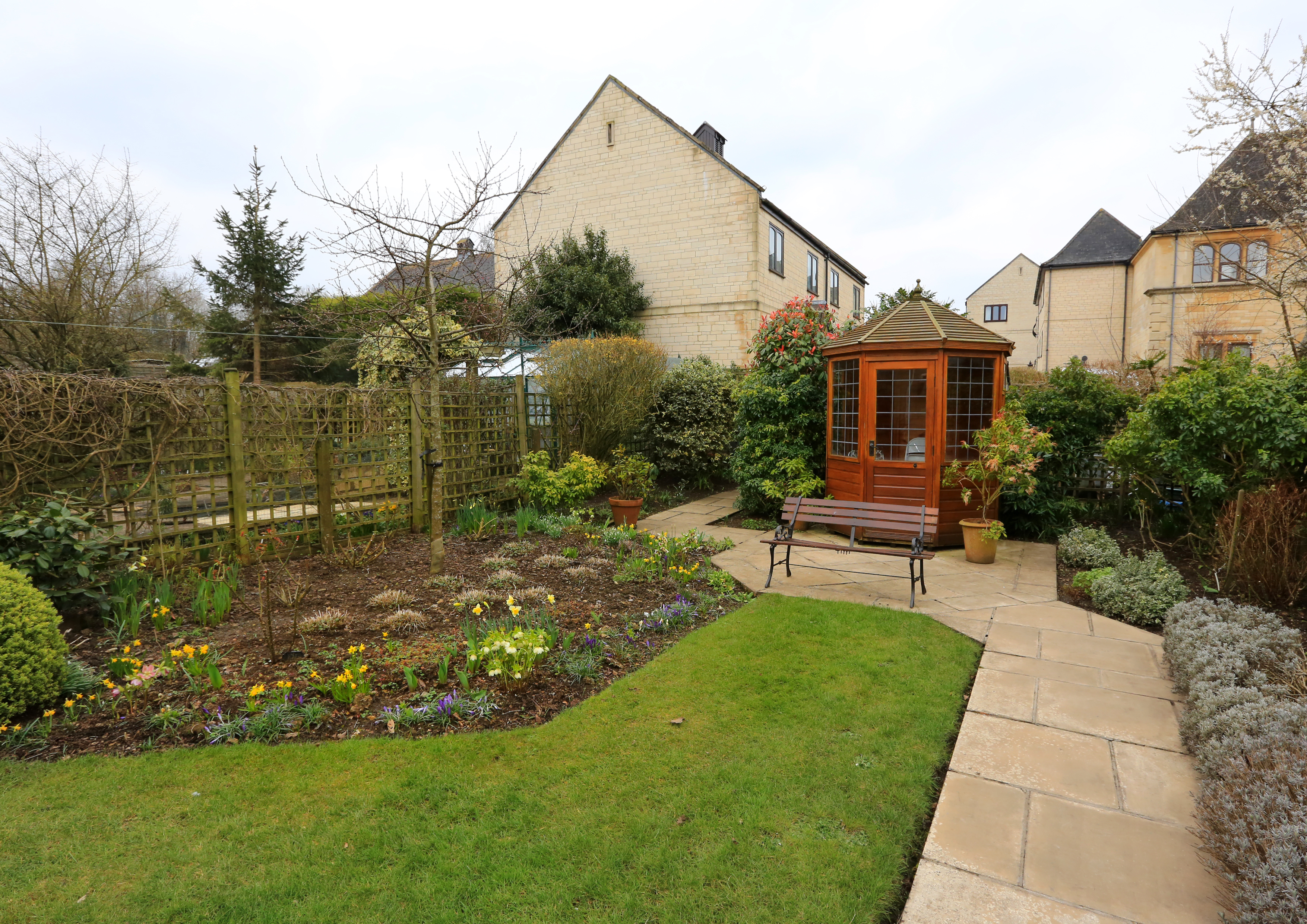 Flower beds and summer house in the garden at Abbeyfield House, Bradford on Avon BA15 1EP