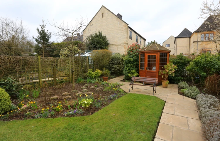 Flower beds and summer house in the garden at Abbeyfield House, Bradford on Avon BA15 1EP