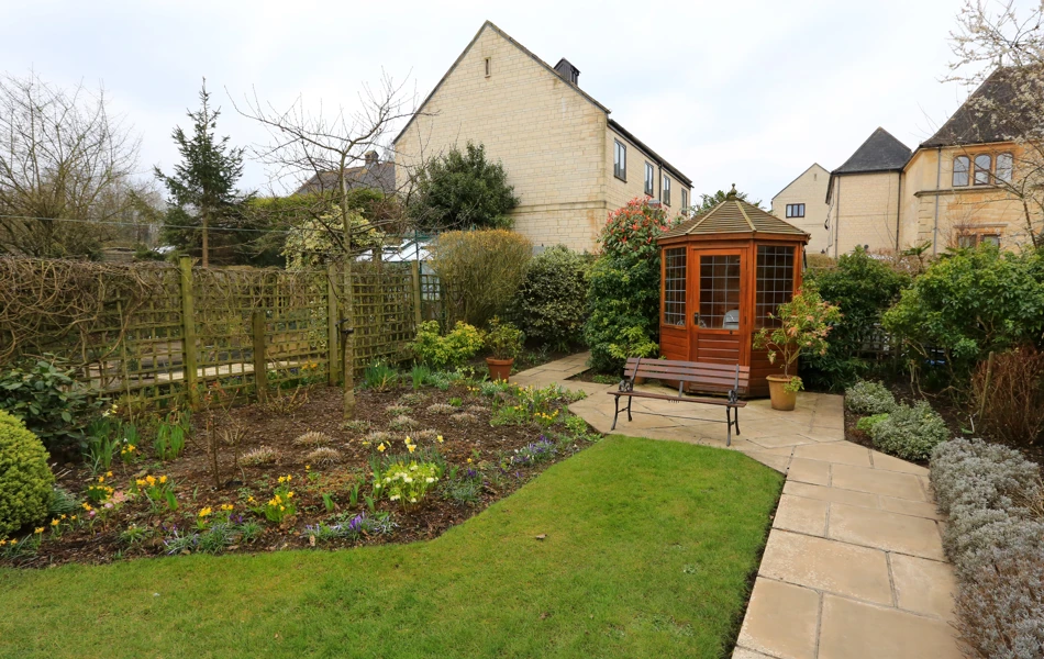 Flower beds and summer house in the garden at Abbeyfield House, Bradford on Avon BA15 1EP