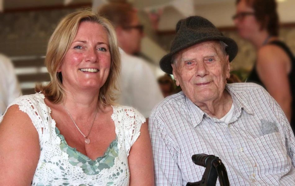 A man and a woman smile for a photo