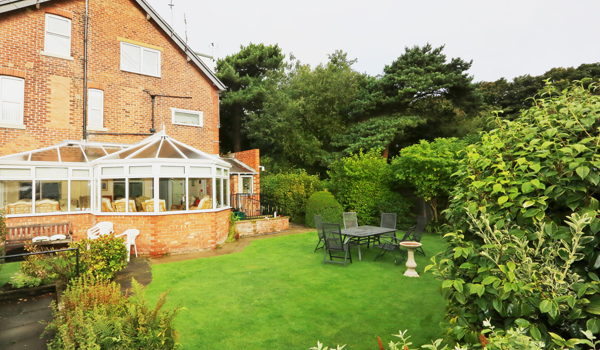Rear garden and conservatory at Abbeyfield House, Lytham St Annes FY8 5NN