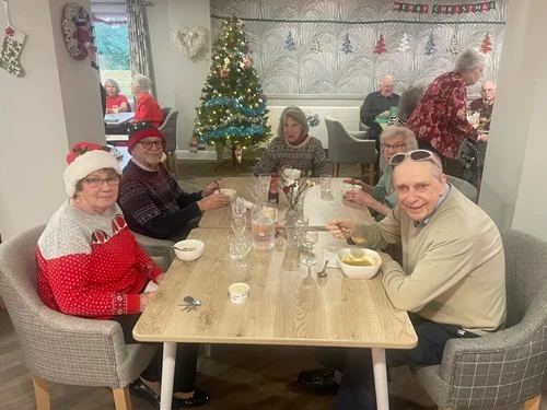 A group of people celebrating christmas lunch 