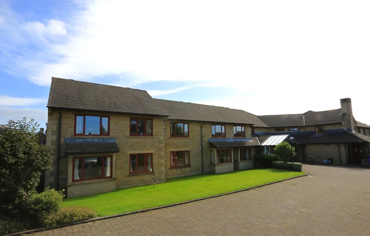 The front of Chirnside House and its bright green lawn