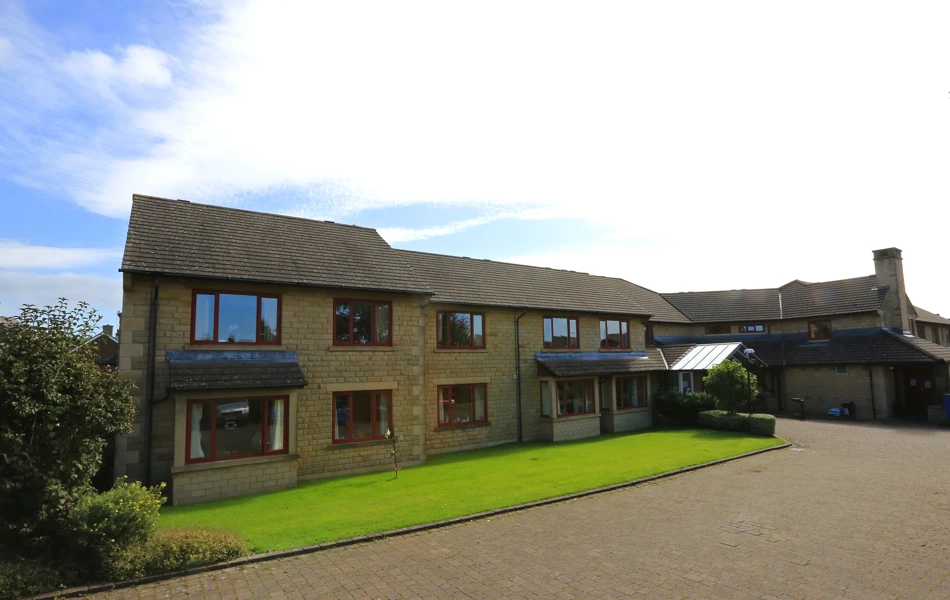 The front of Chirnside House and its bright green lawn