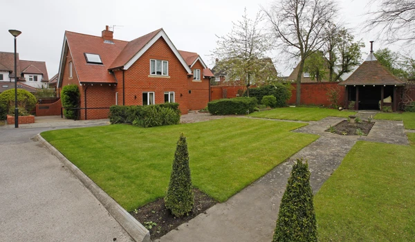 Well kept gardens with conifers and shrubs at Earl Keelan House