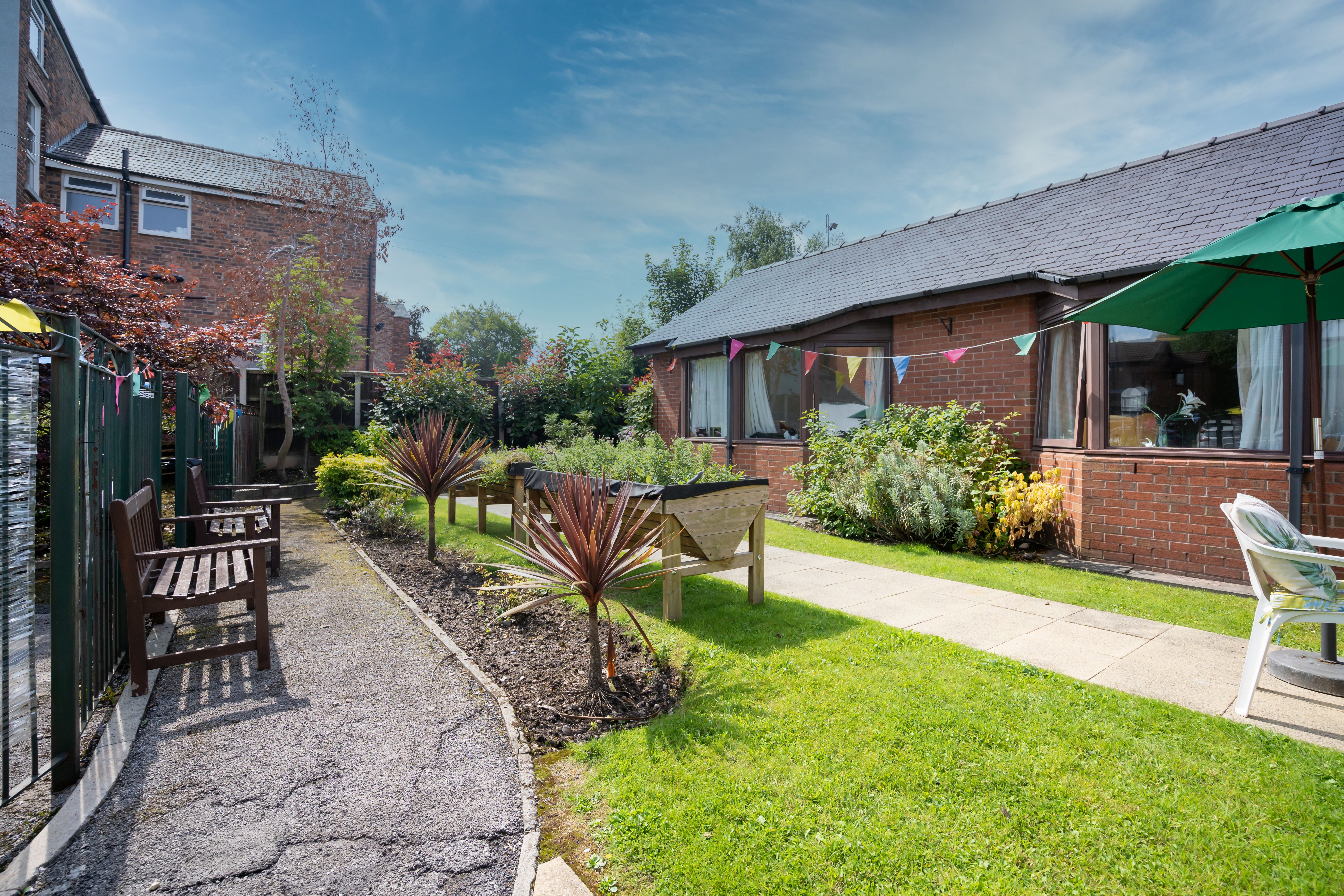 Downing House has seating area for residents to enjoy the garden.