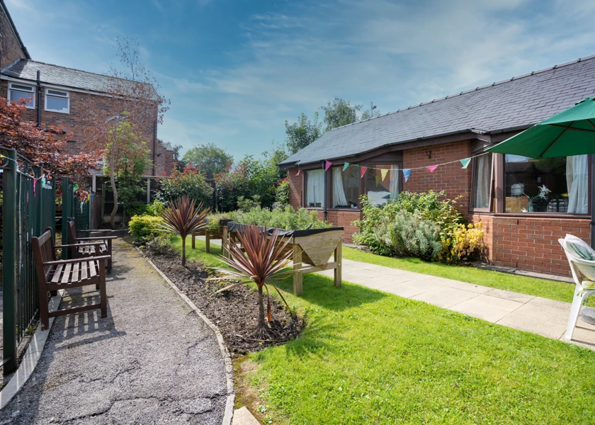 Downing House has seating area for residents to enjoy the garden.