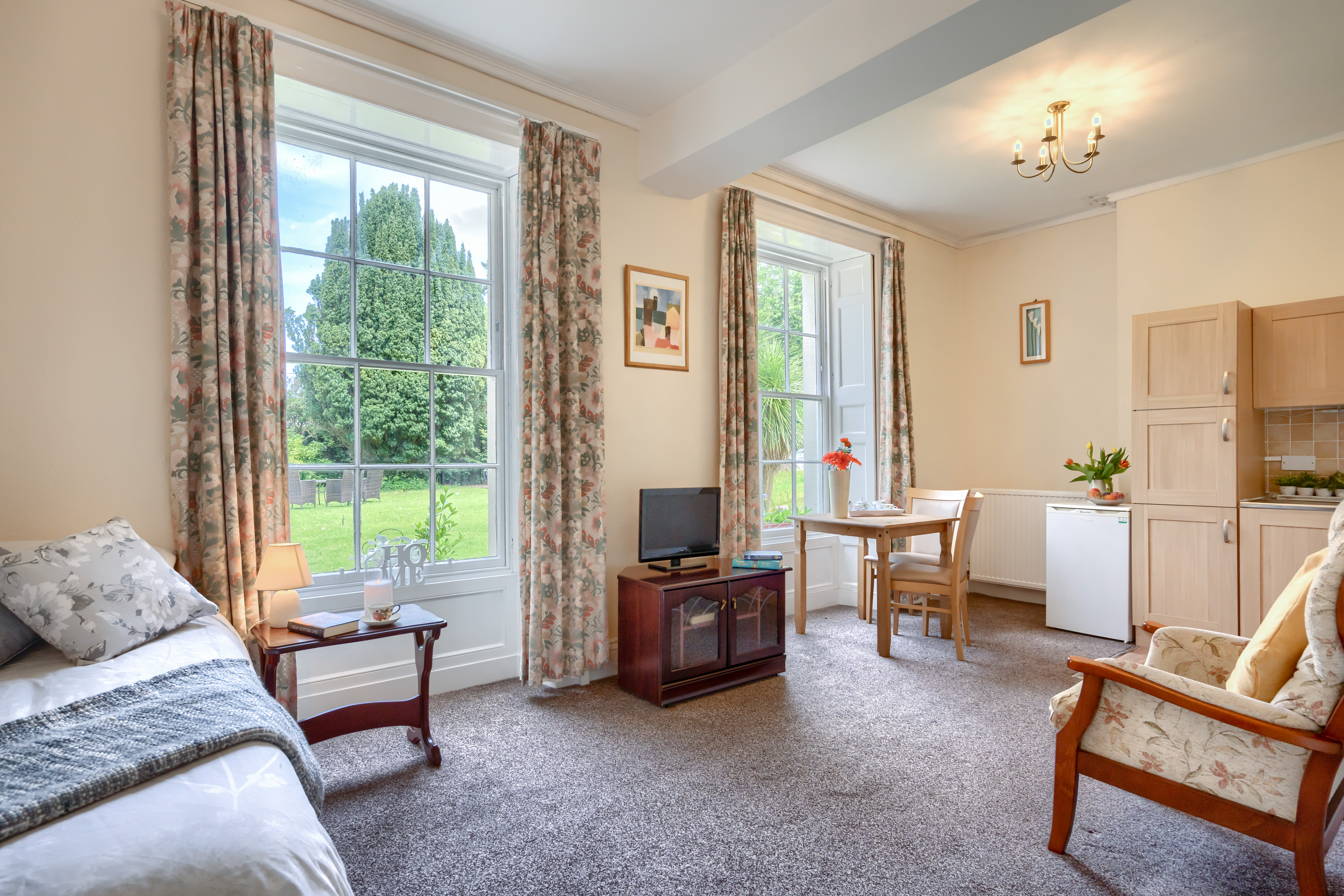 Bedroom With Kitchenette And Lounge Overlooking The Garden