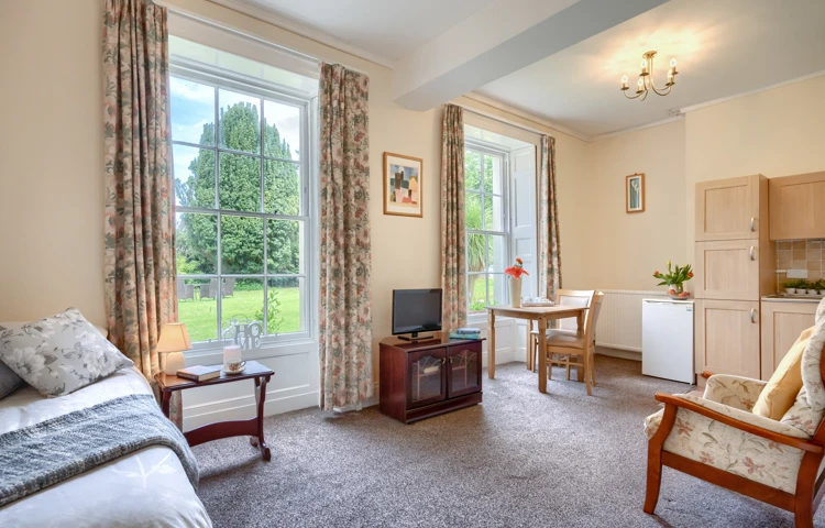 Bedroom With Kitchenette And Lounge Overlooking The Garden
