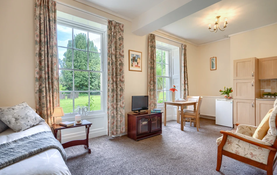 Bedroom With Kitchenette And Lounge Overlooking The Garden