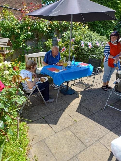 Residents sitting down to eat on the patio