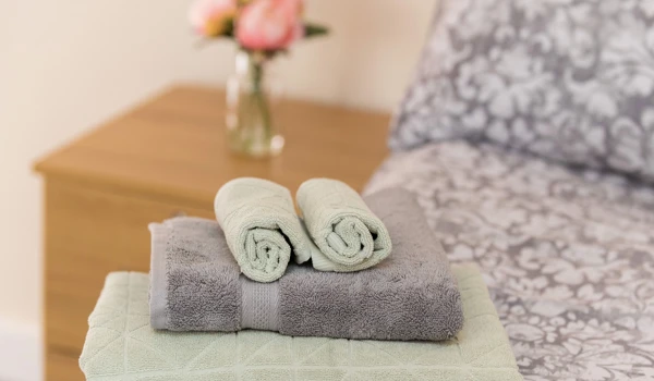 Towels Folded Neatly On Bed