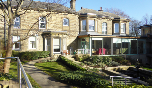 View from outside Abbeyfield Ing Royd with its conservatory, garden and pond independent living in Halifax