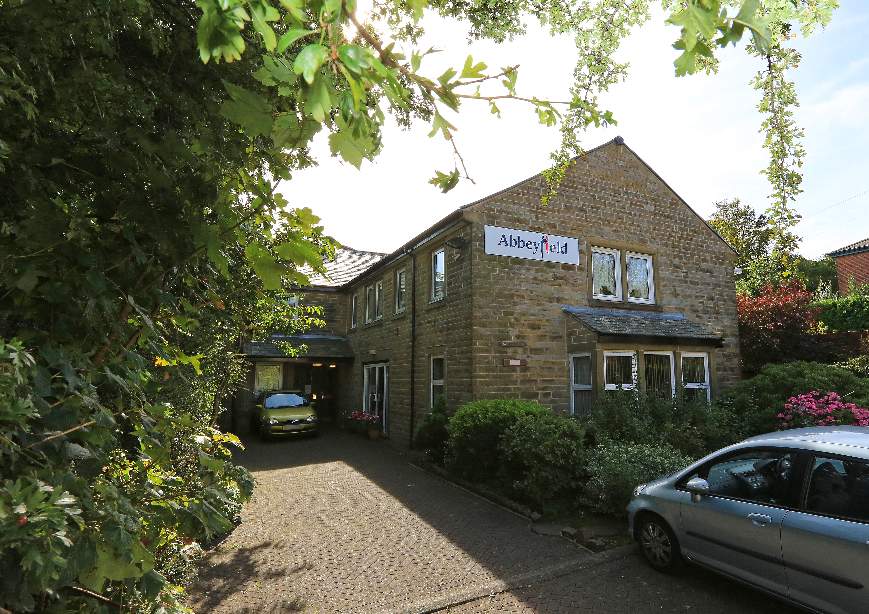 View of the entrance of Abbeyfield House with an Abbeyfield sign on the side