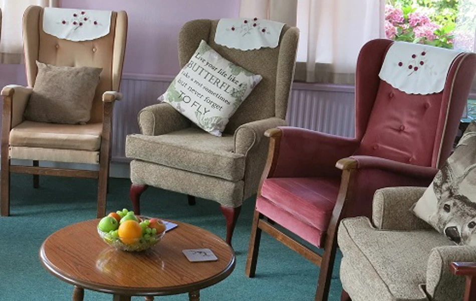 Plenty of comfy chairs and fruit on table in the residents lounge