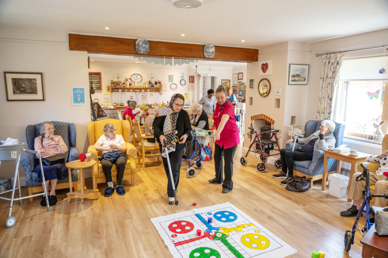 Residents And Staff Enjoying Games And Activities Together