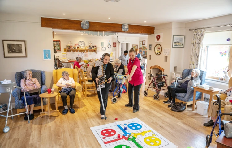 Residents And Staff Enjoying Games And Activities Together