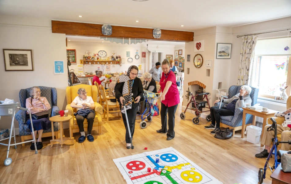 Residents And Staff Enjoying Games And Activities Together