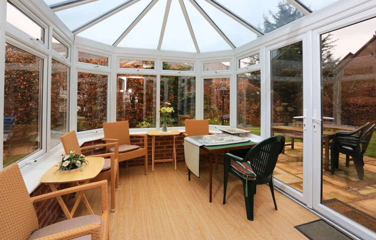 Sit back and relax in our conservatory with view of the garden at Bailey House
