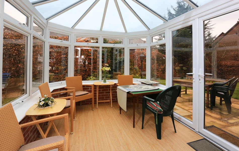 Sit back and relax in our conservatory with view of the garden at Bailey House