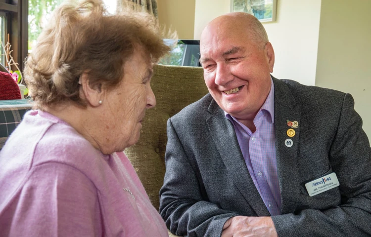 A volunteer sat talking with a resident