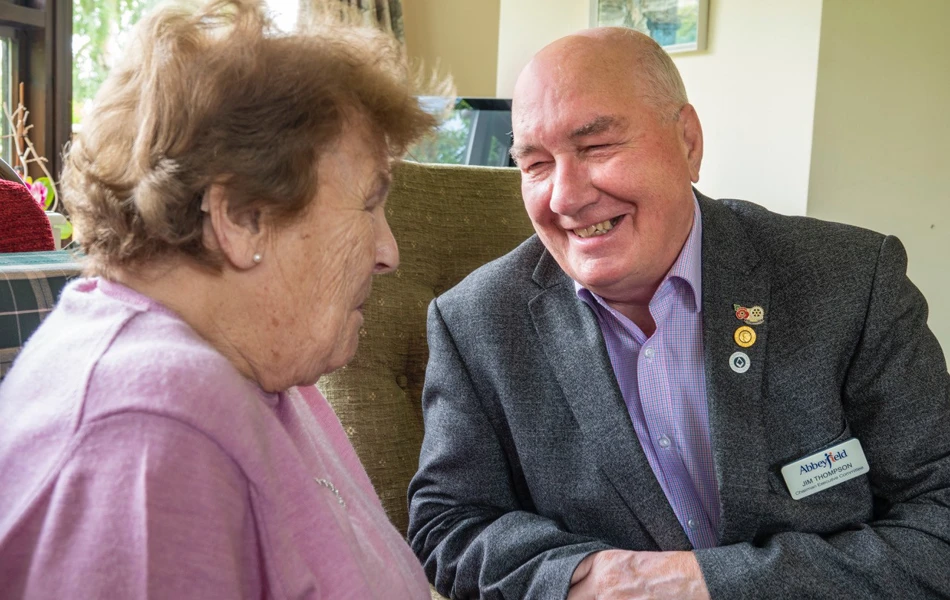 A volunteer sat talking with a resident