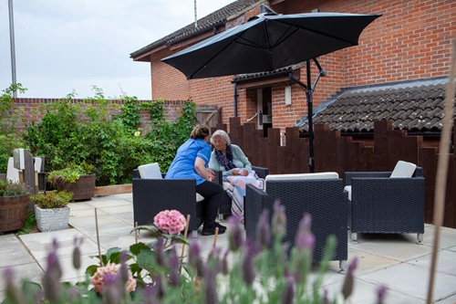 Resident And Staff Member In The Garden at Friars Mead, Kings Langley WD4 8DR